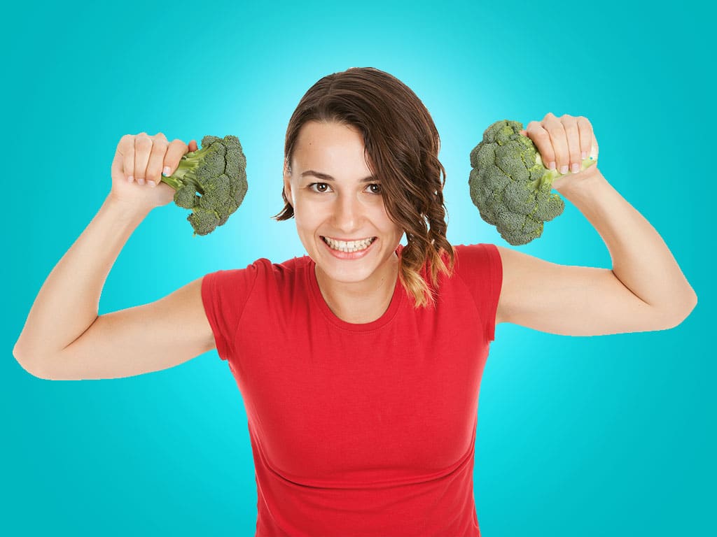 plants to start now: young woman holding broccoli in her hands