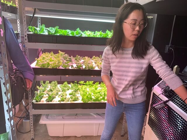 Purdue University student in front of Happy Leaf LED grow lighting setup