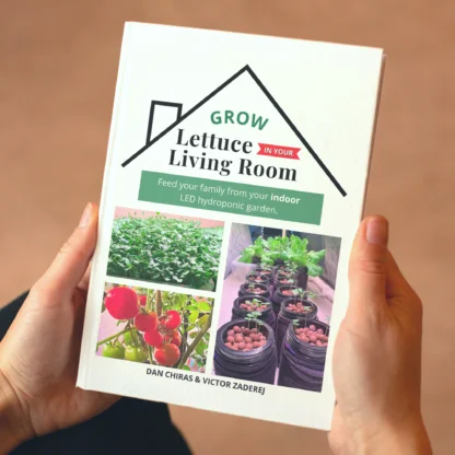 Man holding book about indoor hydroponic growing