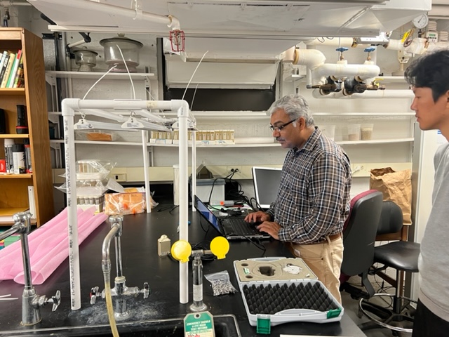 dr nemali and student setting up happy leaf grow lights