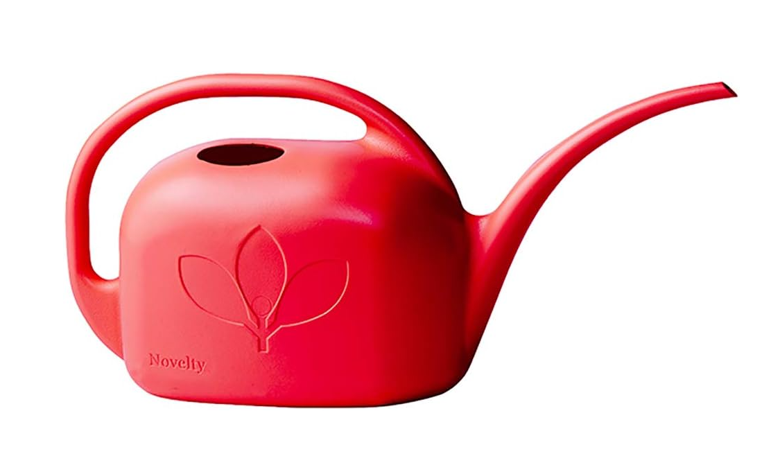 Red watering can on white background